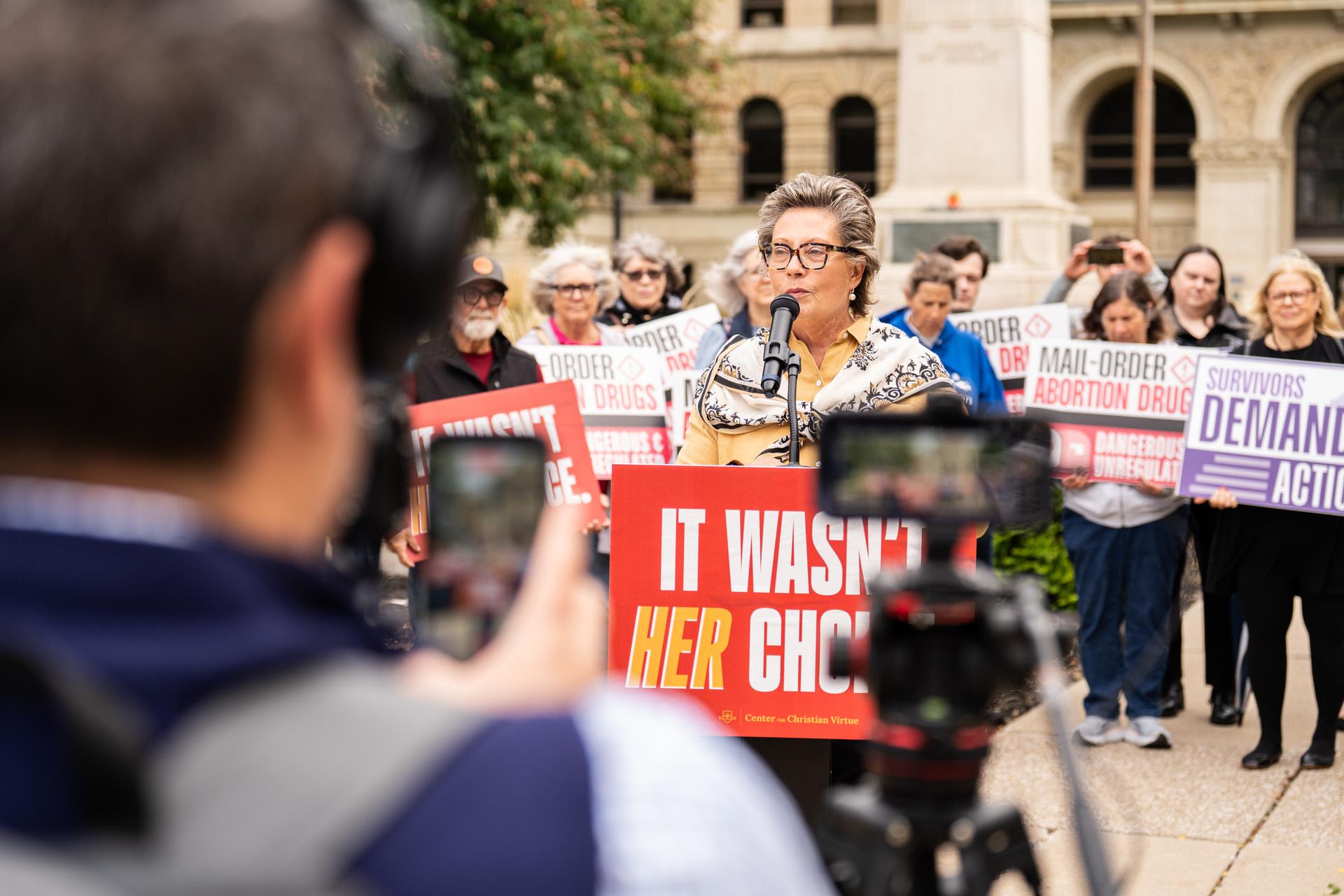 A speaker addresses the press conference outside the Lucas County Courthouse