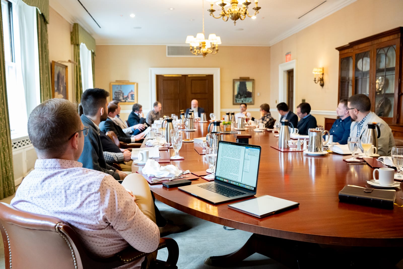 People seated around a conference table in a meeting room.