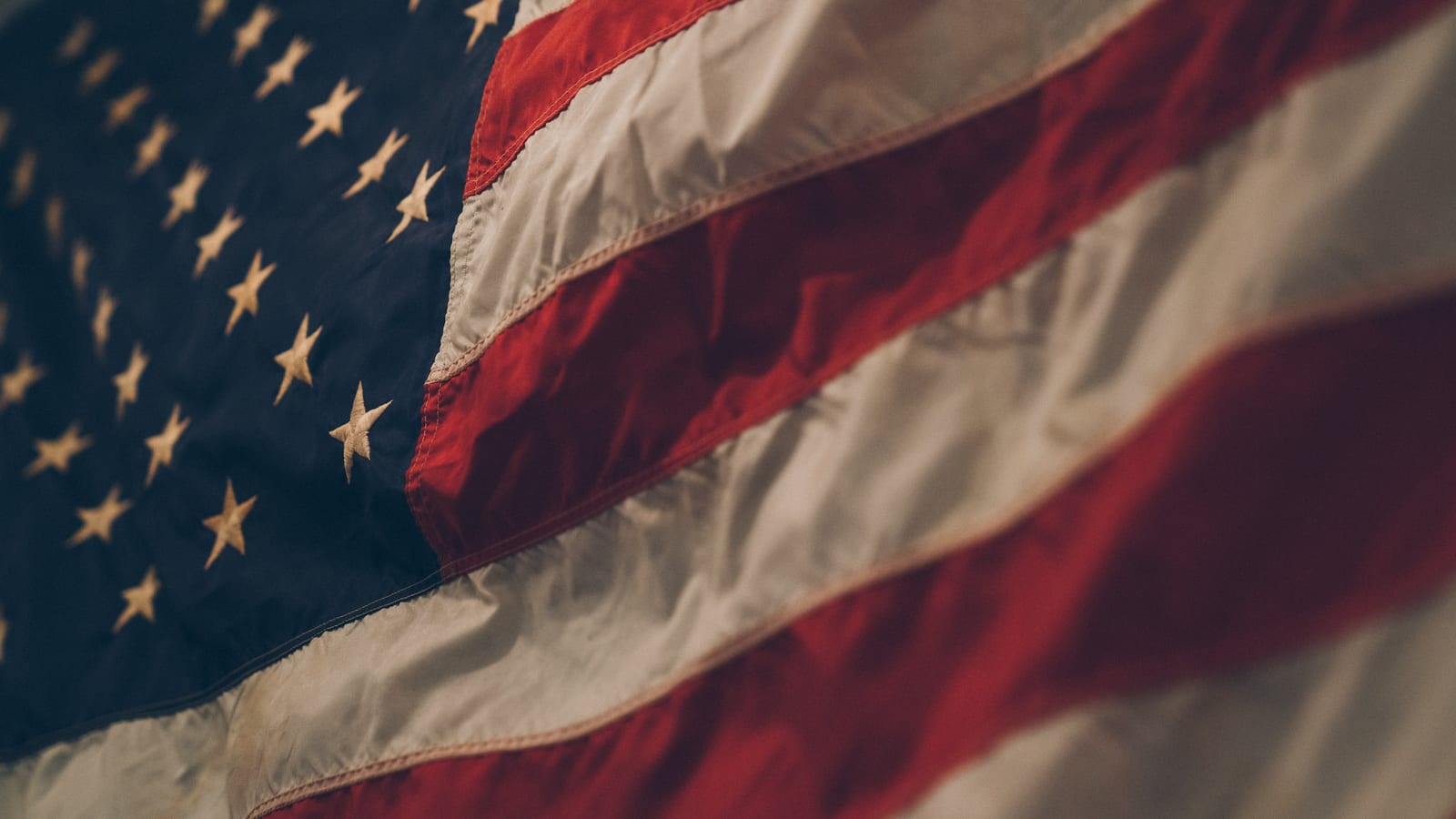 Close-up of the American flag with stars and red-and-white stripes.