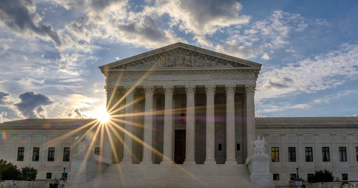 The Supreme Court building in Washington, D.C. at sunset.
